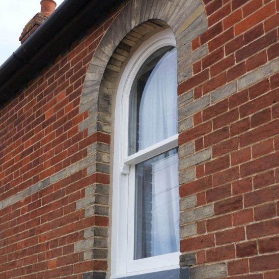 Arched timber sash window in white