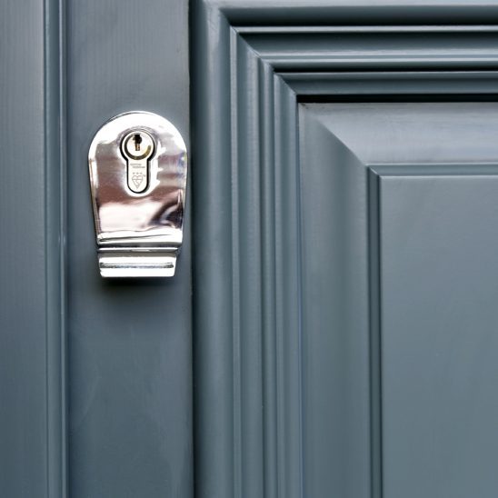Polished chrome escutcheon on timber entrance door