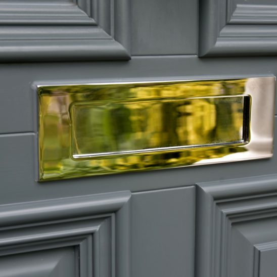 Polished chrome letterbox on timber entrance door