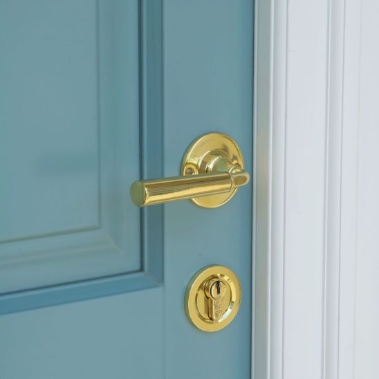 Polished brass door handle and lock on Timber Entrance Door