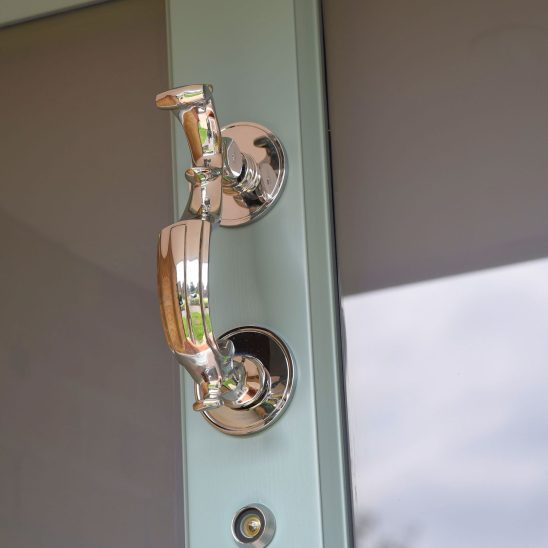 Doctors door knocker in polished chrome on timber entrance door