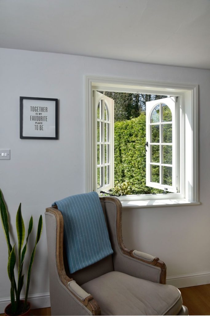 Cottage flush timber casement windows in off-white with 18mm astragal bars and true arch swept heads