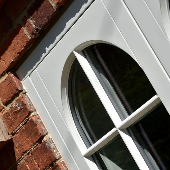 Cottage flush timber casement windows in off-white with 18mm astragal bars and true arch swept heads