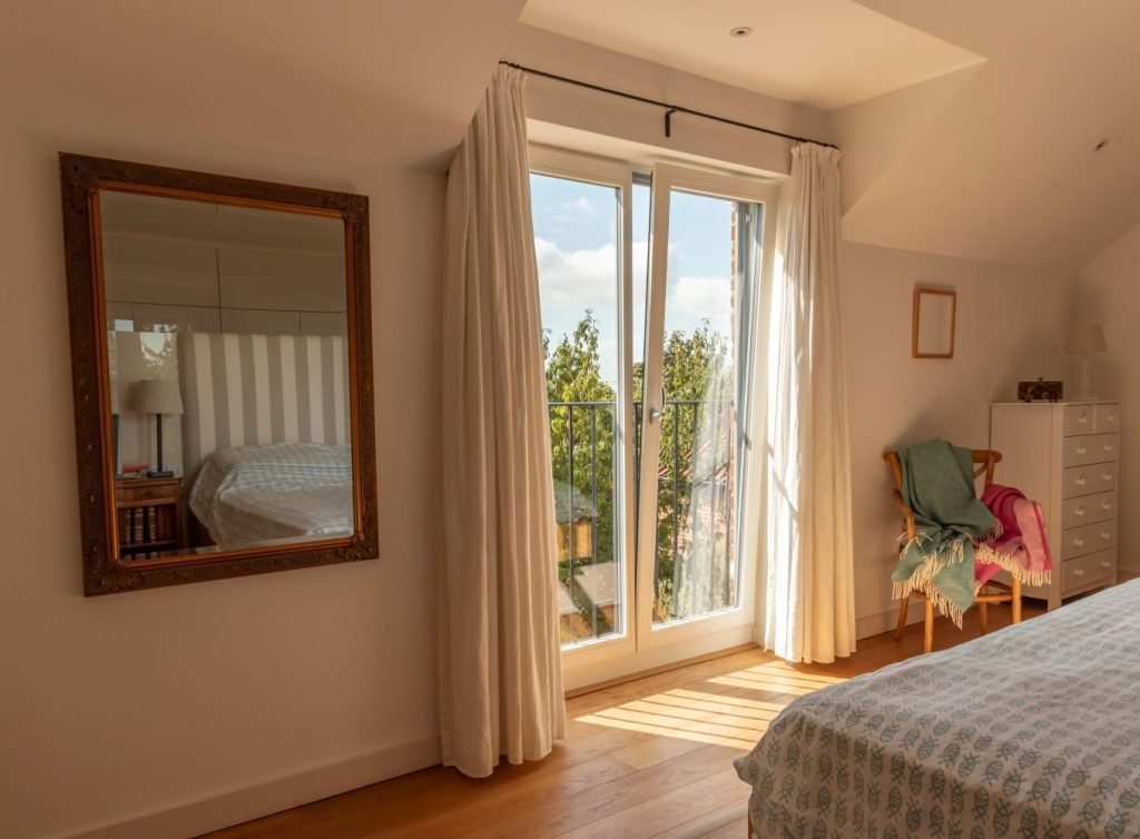 Timber French tilt and turn windows in Window Grey on the outside and pure white on the inside, with tilt and turn feature to allow a small fixed opening for ventilation.