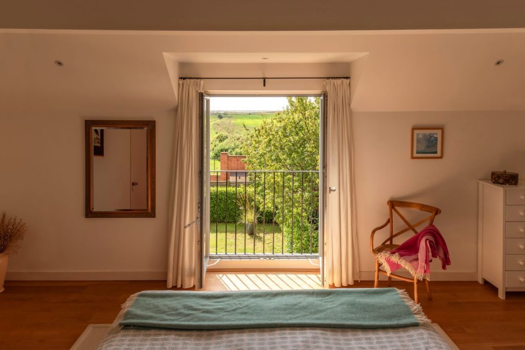 Timber French tilt and turn windows in the fully open position Window Grey on the outside and pure white on the inside