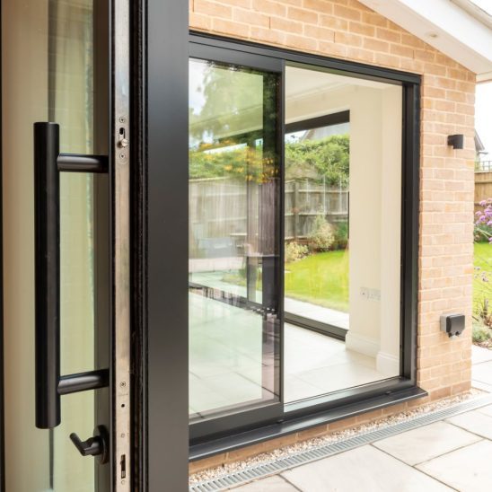 Sunflex SVG20 aluminium sliding doors in black, with super slim 20mm interlock and colour coded bar handle