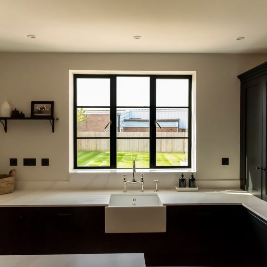 Steel look aluminium windows in black with astragal bars