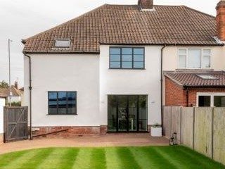 Steel look aluminium French doors and windows in black with astragal bars
