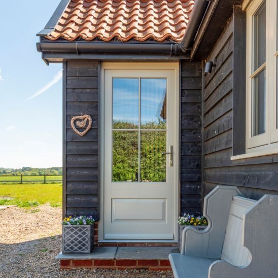 French grey Bardwell front timber door, raised and fielded panel and polished chrome hinges. Polished nickel newbury door furniture