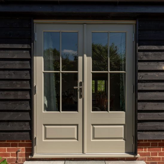 'Bardwell' timber French doors in French Grey with 18mm glazing bars and a raised and fielded door panel. Newbury polished nickel lever handle