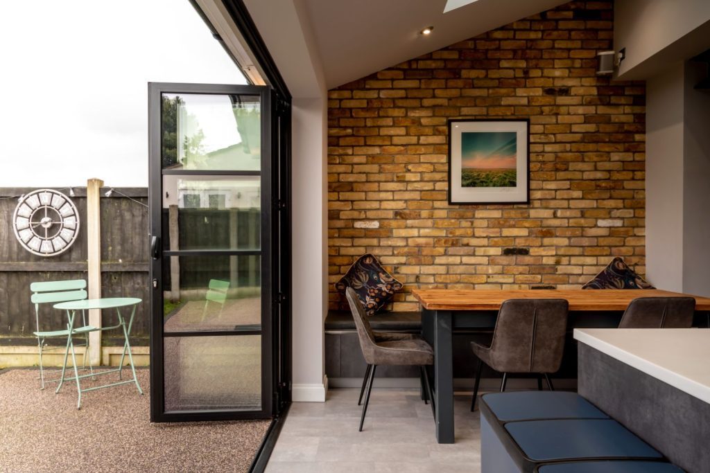 Slim stacking Sunflex bifold doors in graphite black with 30mm heritage style bars