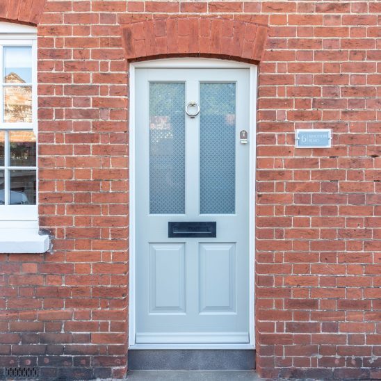 Timber Kingston front door in French Grey with off-white frame, etched star glass and 316 Coastal stainless steel ring knocker. letterbox and handle