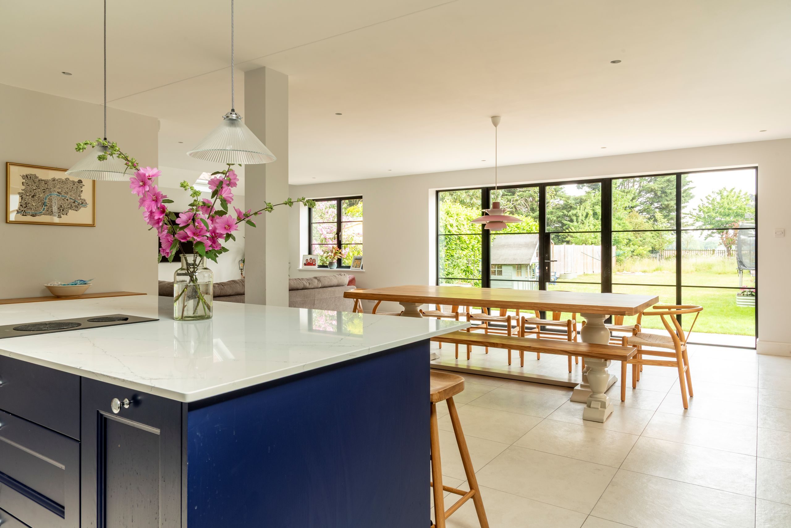 Lounge, dining and kitchen area with large art-deco windows and doors