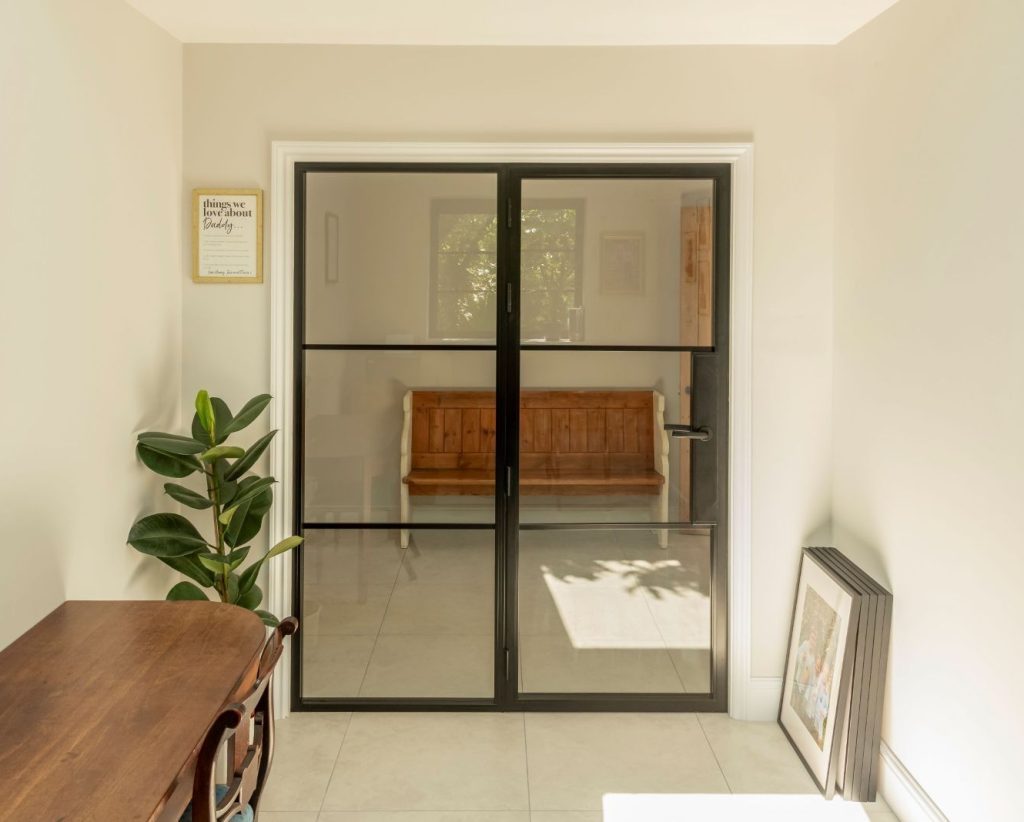 Aluco aluminium steel look internal glazed door with side panel, super slim 20mm glazing bars and Leon handle in matt Black
