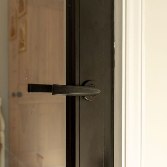 Aluco aluminium steel look internal glazed door with side panel, super slim 20mm glazing bars and Leon handle in matt Black
