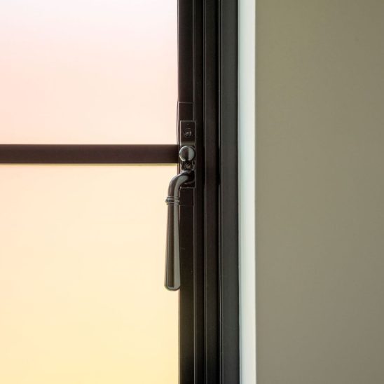 Aluco aluminium steel look window with super slim glazing bars in matt Black with Newbury handle and sandblasted obscured glass