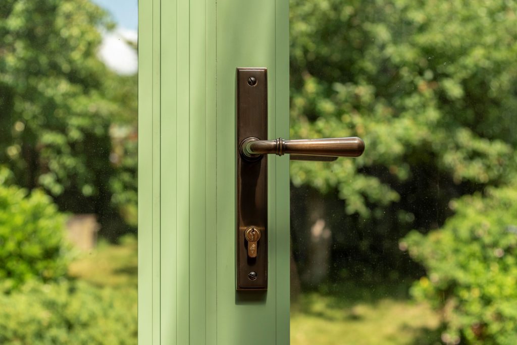 Close up picture of steel look art-deco door handle on Aluco Green steel look French doors