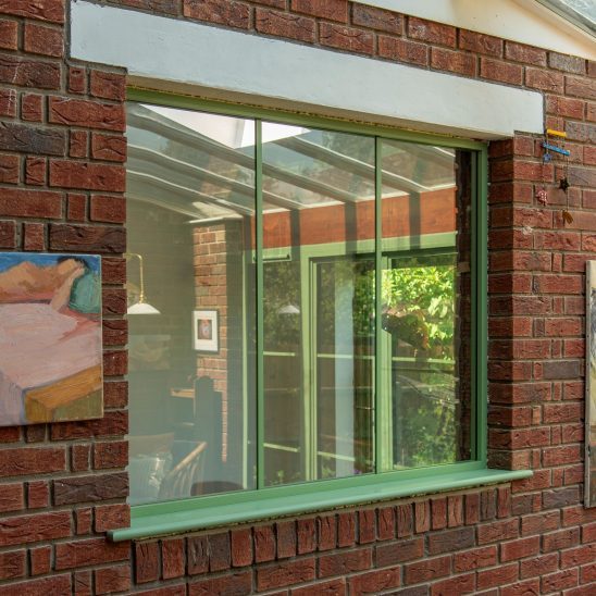 Green Aluco steel look internal fixed window screen.