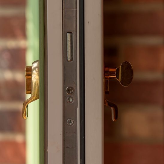 Evolution Ballingdon PVCu entrance door with brass escutcheon, internal thumb turn and integrated locking for advanced security
