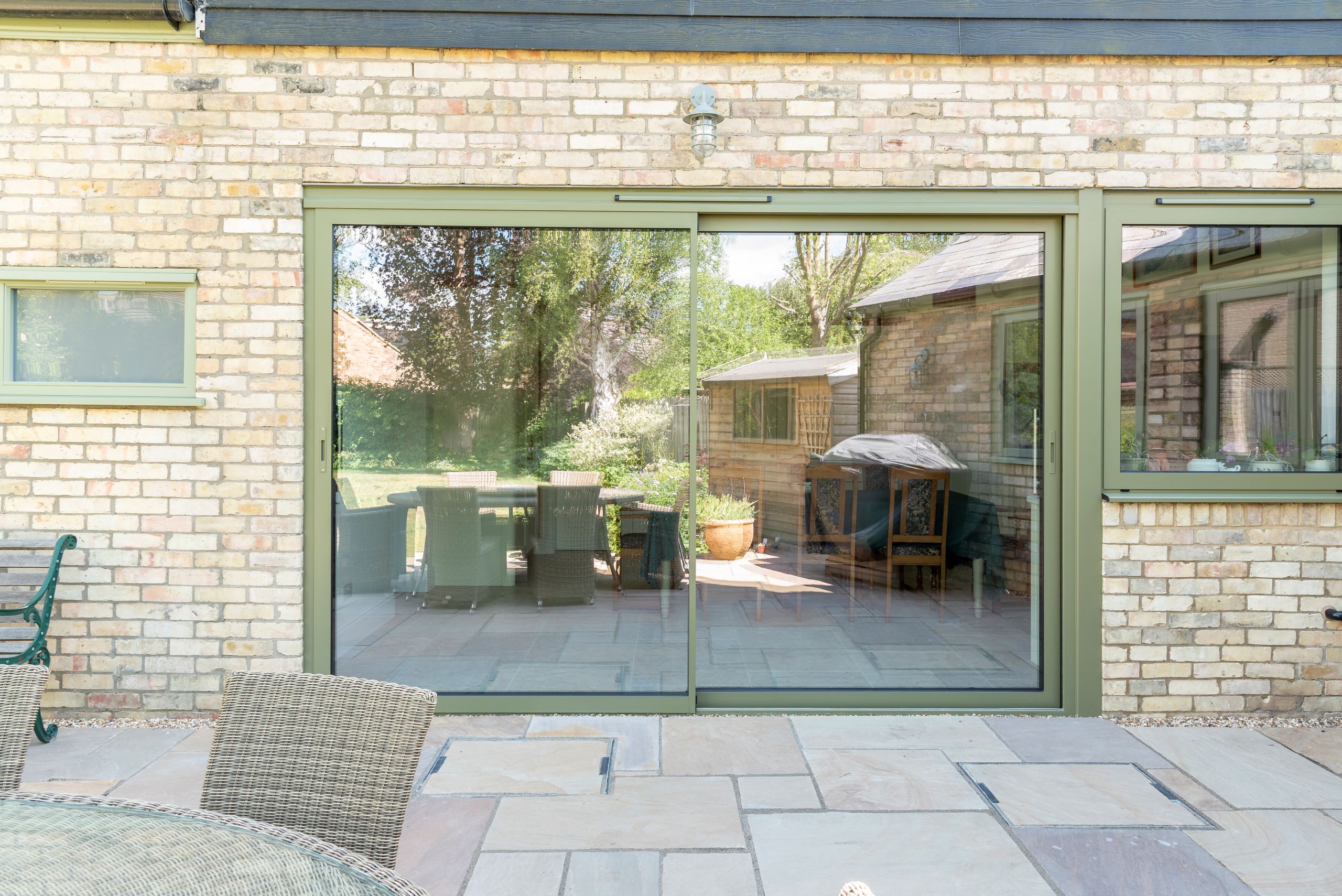 Sunflex slimline sliding doors with matching aluminium windows in a brick new extension.