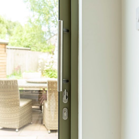 Sunflex SVG30 sliding doors in green with stainless steel bar handle and lock