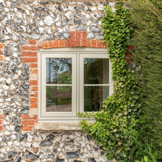 Evolution PVCu flush casement window with a single horizontal Georgian bar in Olive Grey