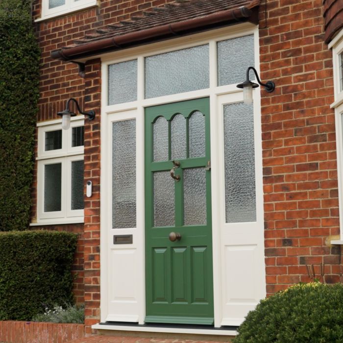 picture of timber green front door with cream wood side panels