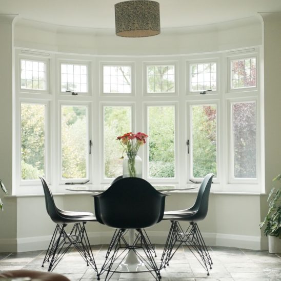 White engineered timber casement windows with leaded lights