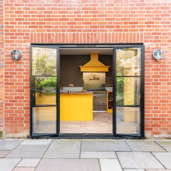 Black heritage, Art Deco aluminium patio doors with floating lock detail, slim glazing bars and side panels