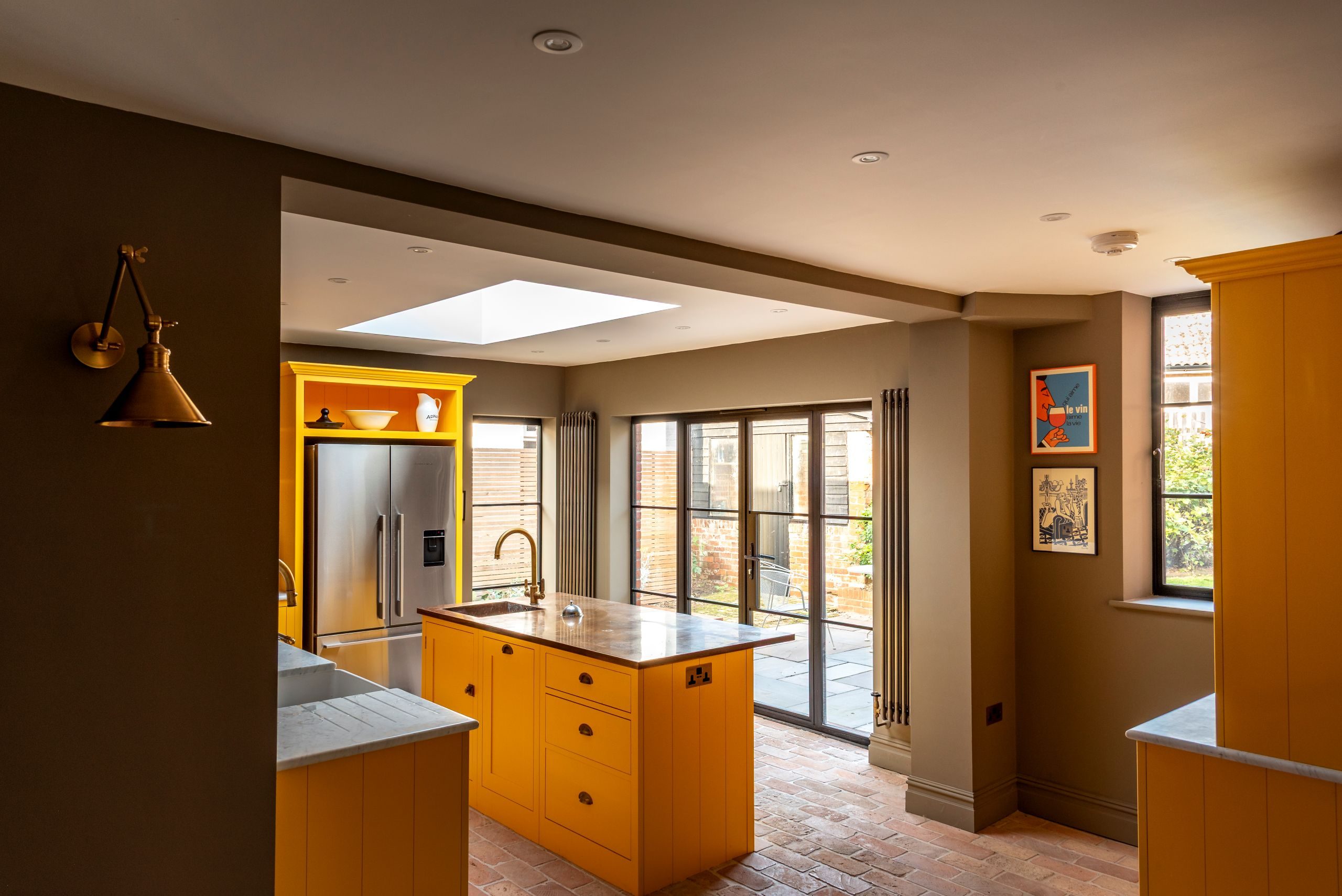 Contemporary kitchen with black aluminium heritage glazing and Patio doors featuring ultra slim glazing bars in Orford home