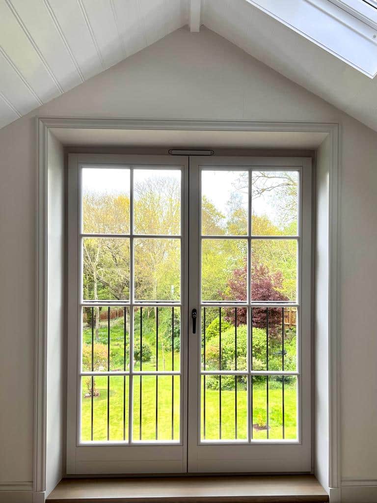 Tilt and turn windows in a door design behind juliet balcony closed