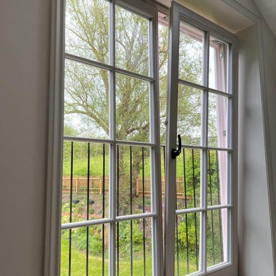 Tilt and turn windows in a door design behind juliet balcony tilted back