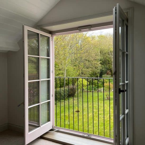 Tilt and turn windows in a door design behind juliet balcony fully open